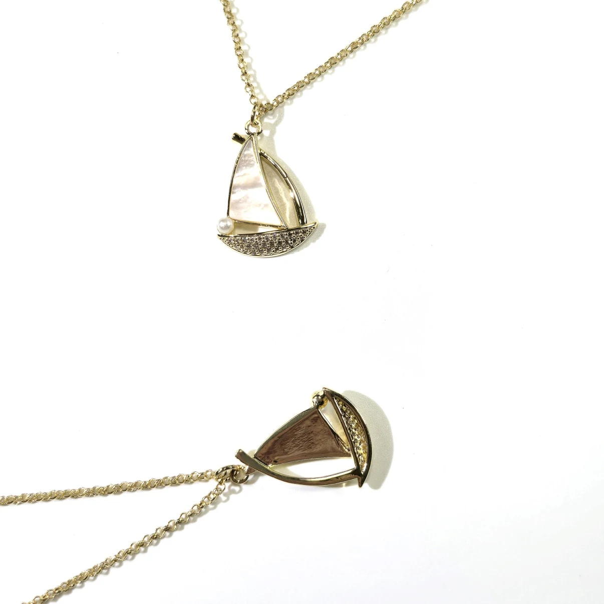 Sailboat pendant detail with genuine mother-of-pearl sail and pearl accent