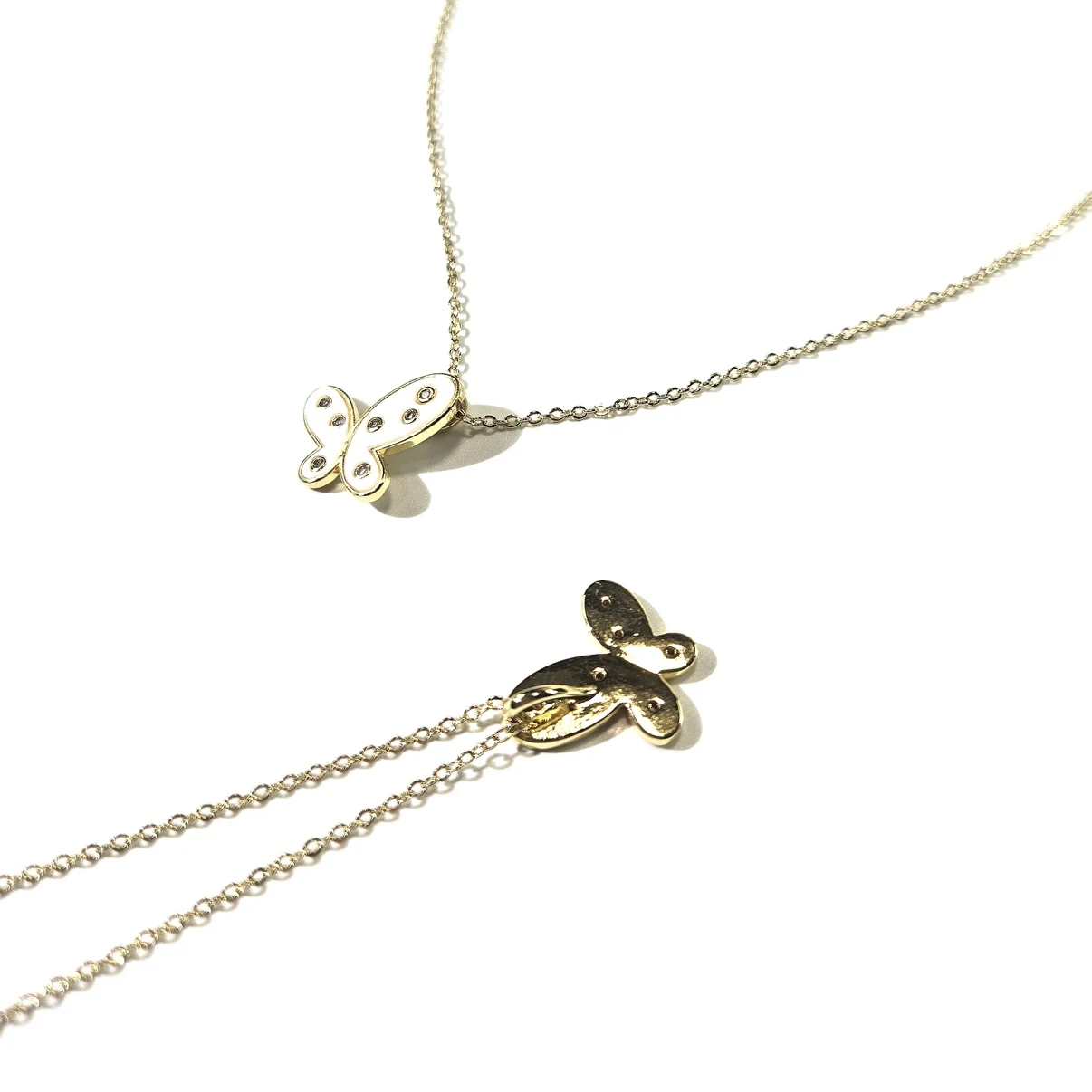 Butterfly pendant front and back detail with crystal-dotted wings