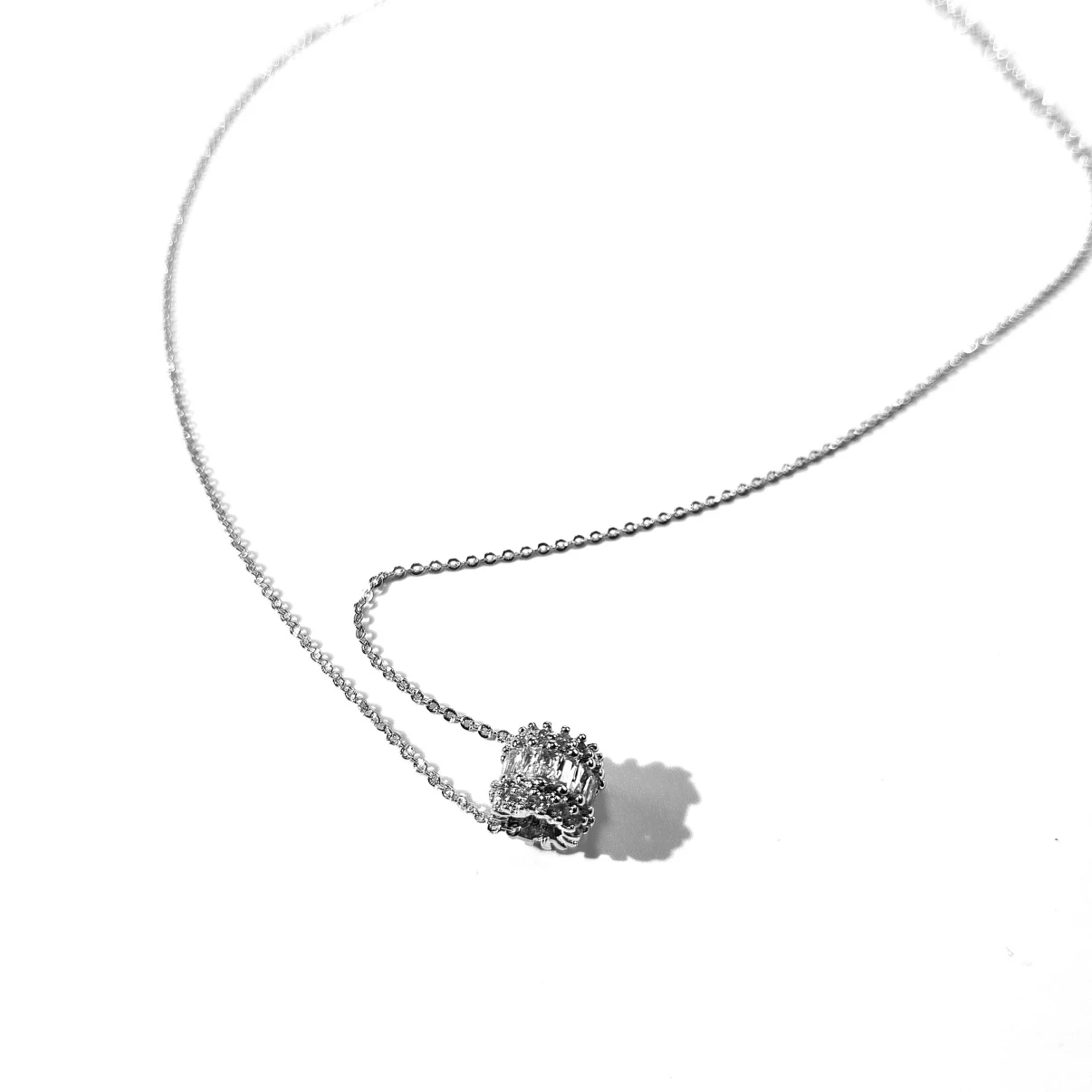 Close-up of baguette cubic zirconia barrel pendant