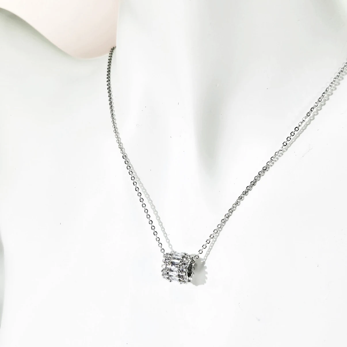 Cubic zirconia pendant necklace styled on display bust